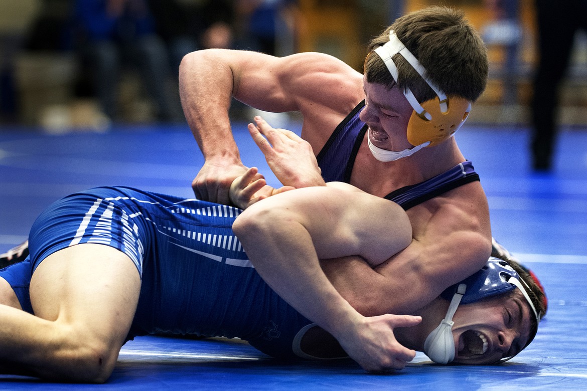 POLSON HIGH School wrestling is Jarrod Farrier  in a battle with Columbia Falls wrestler Easton Sempf. (photo by Jeremy Weber/Hungry Horse News)