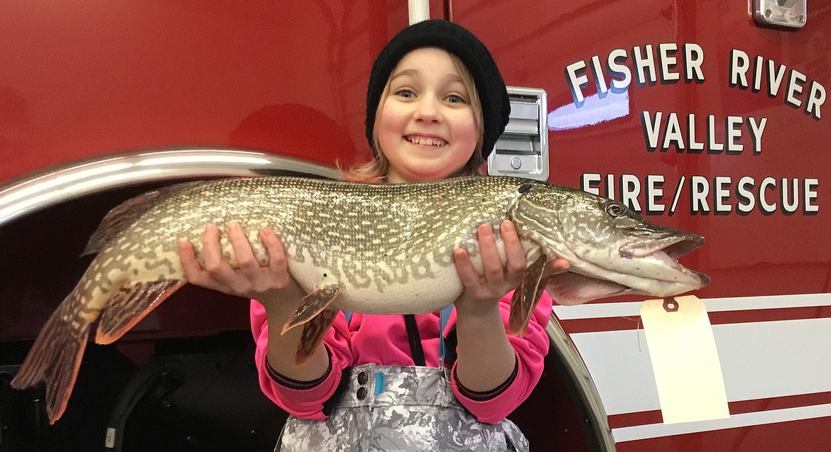 Ella Thylin of Kalispell holds the pike she caught during the Fisher River Valley Fire/Rescue Winter Ice Fishing Derby at Lower Thompson Chain of Lakes last weekend. (Courtesy photos)
