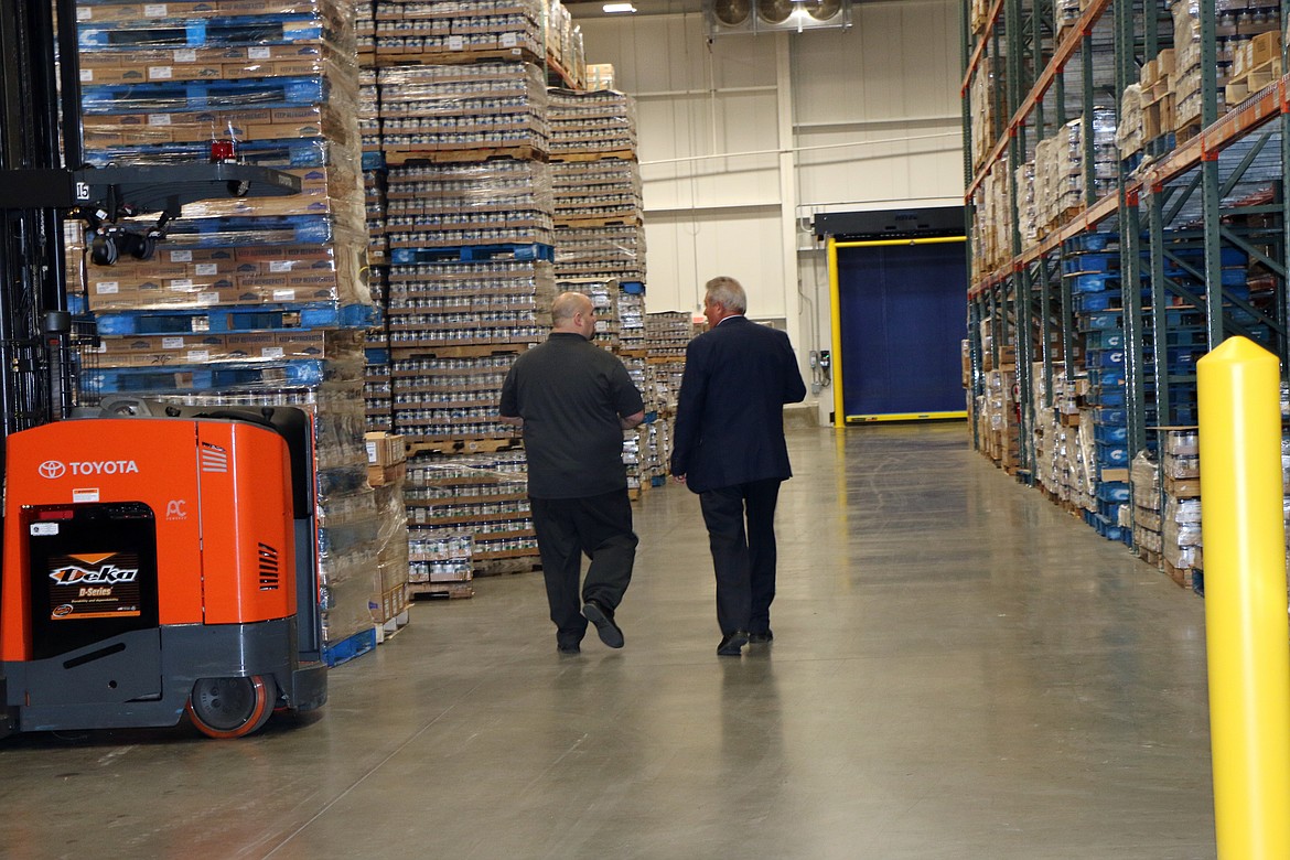 (Photo by CAROLINE LOBSINGER)LItehouse President and CEO Jim Frank, right, walks through the company new cooler, part of a $6.2 million expansion of its Sandpoint production facility.