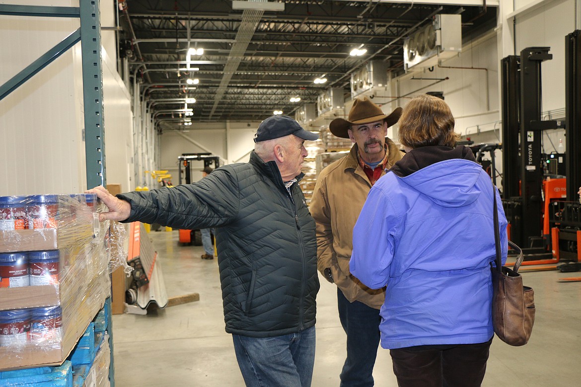 (Photo by CAROLINE LOBSINGER)Doug Hawkins, left, and Ed Hawkins, center, talk to another attendee of Litehouse's ribbon-cutting ceremony Wednesday. The Hawkins family founded the company at their Hope restaurant more than 50 years ago.