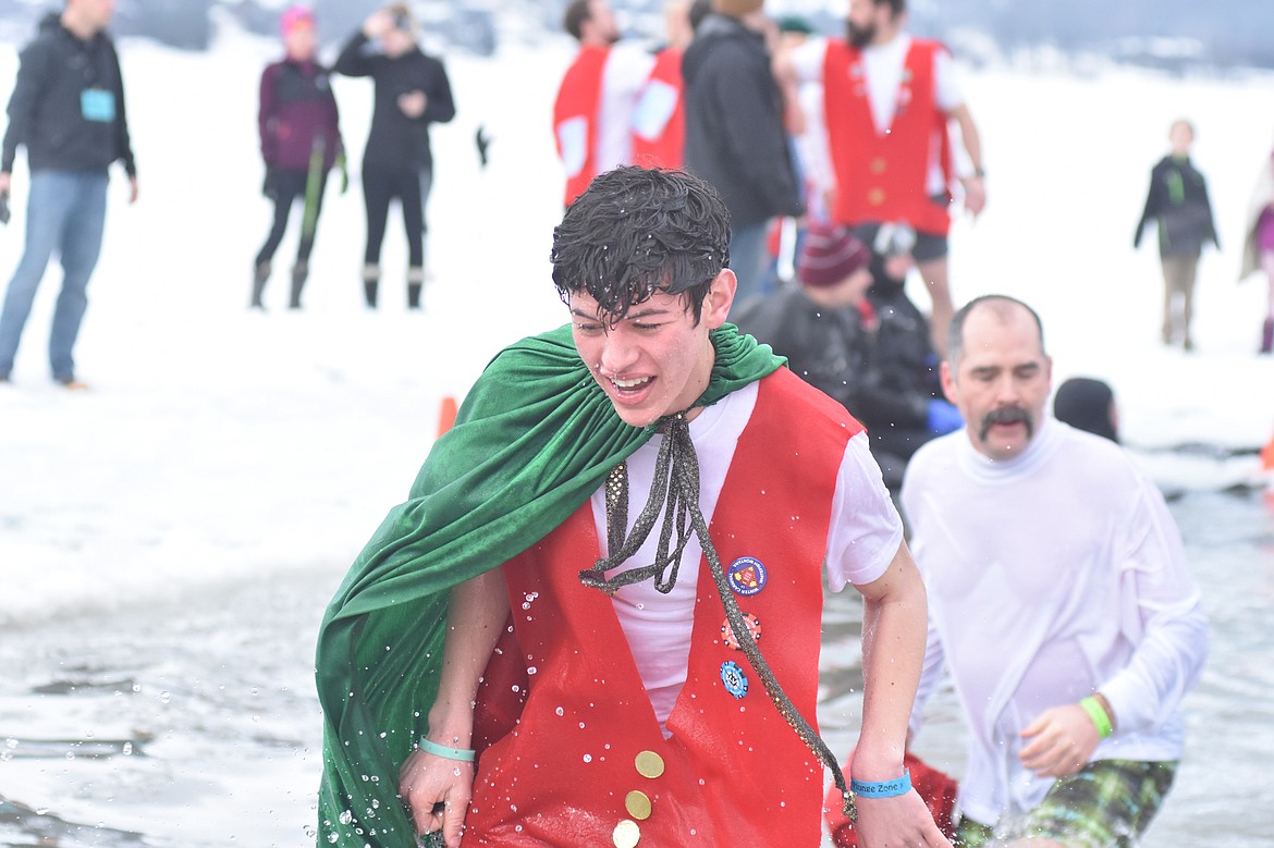 Winter Carnival Prince Frey Anthony Smith emerges from the icy waters of Whitefish Lake Saturday morning for the Whitefish Winter Carnival Penguin Plunge, which benefits Special Olympics Montana. (Heidi Desch/Whitefish Pilot)