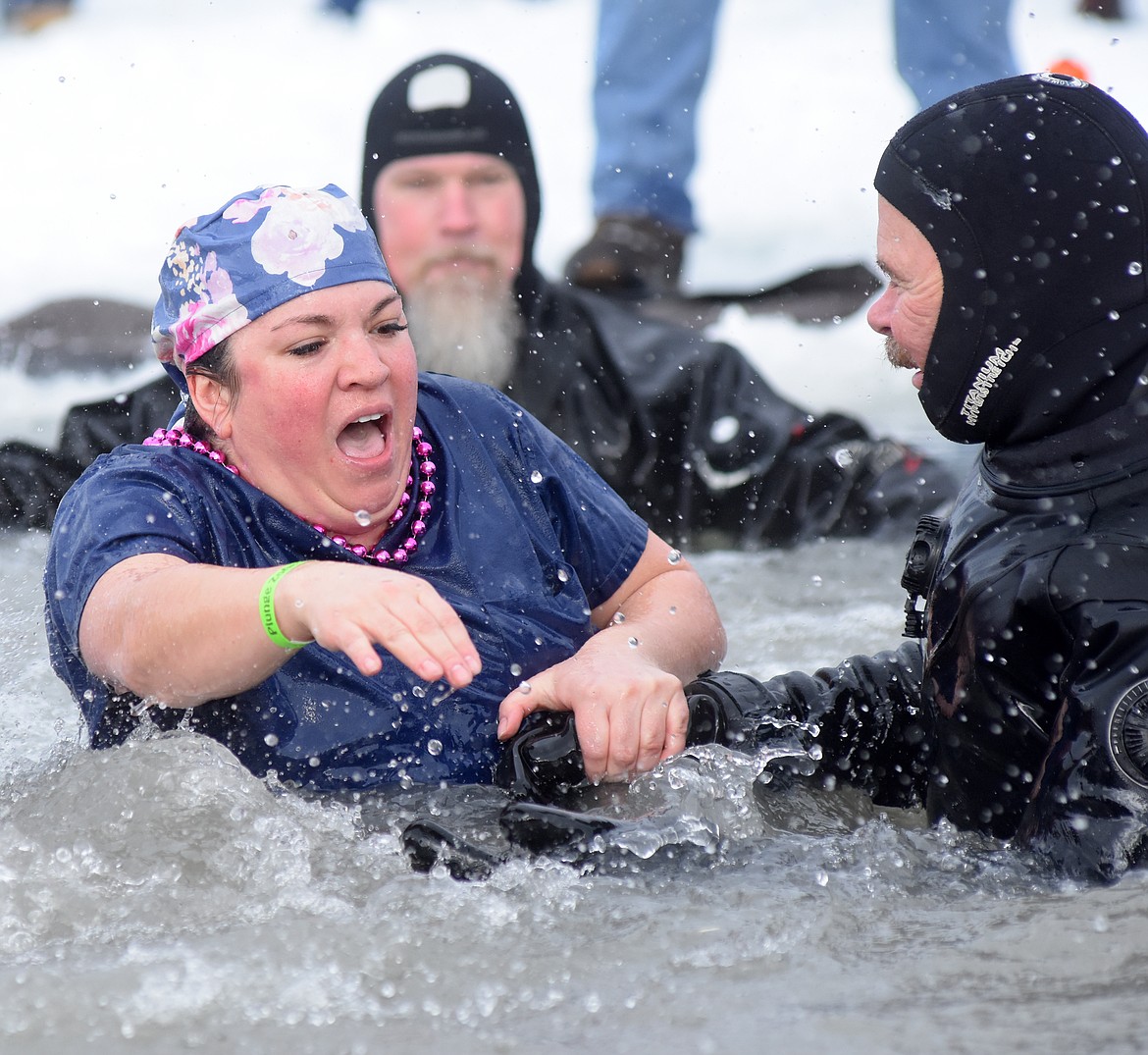 A member of the North Valley Hospital team reacts after jumping to Whitefish Lake Saturday morning for the annual Penguin Plunge. (Heidi Desch/Whitefish Pilot)