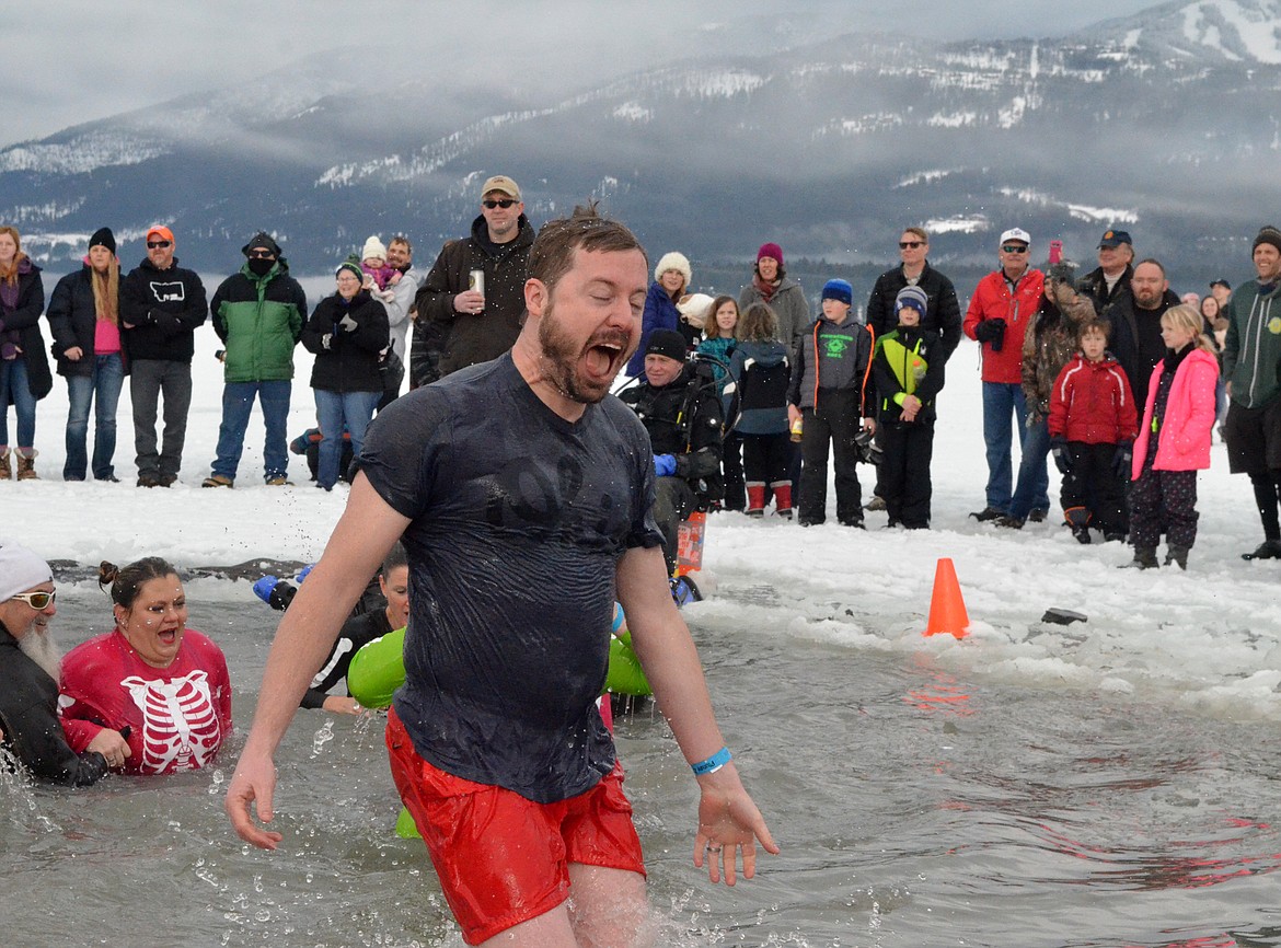 A participant comes out of the icy waters of Whitefish Lake Saturday morning during the Whitefish Winter Carnival Penguin Plunge, which benefits Special Olympics Montana. (Heidi Desch/Whitefish Pilot)