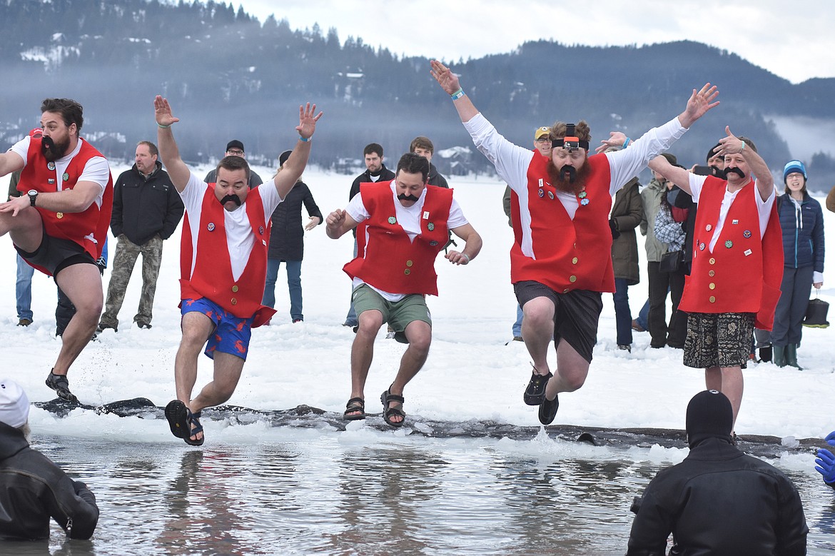 The National Parks Realty team, dressed as Carnival &quot;Primes&quot; jump into Whitefish Lake during the Penguin Plunge. (Heidi Desch/Whitefish Pilot)