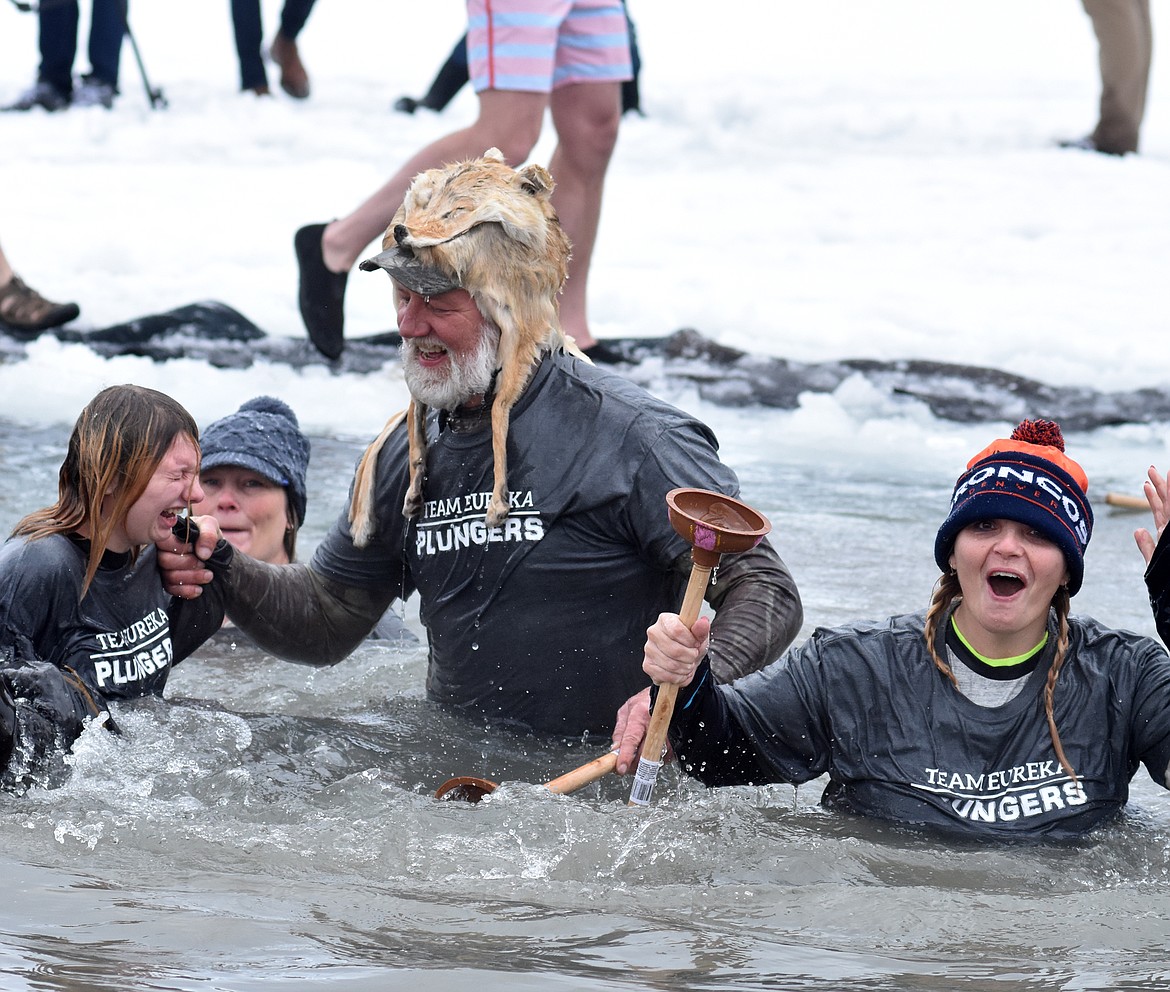 Members of the Eureka Plungers team emerge from the icy waters of Whitefish Lake Saturday morning for the Whitefish Winter Carnival Penguin Plunge, which benefits Special Olympics Montana. (Heidi Desch/Whitefish Pilot)