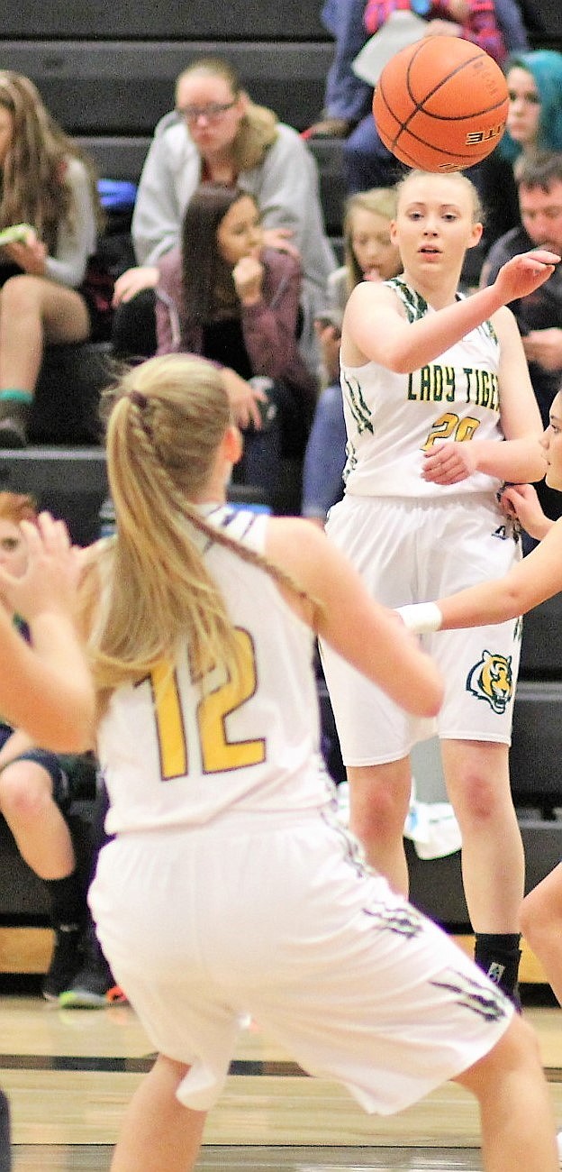 St. Regis Lady Tiger, Anna Sanford, makes a pass to teammate, Emma Hill. The Tigers won over Two Eagle, 63-22 on Feb. 2. (Kathleen Woodford/Mineral Independent)