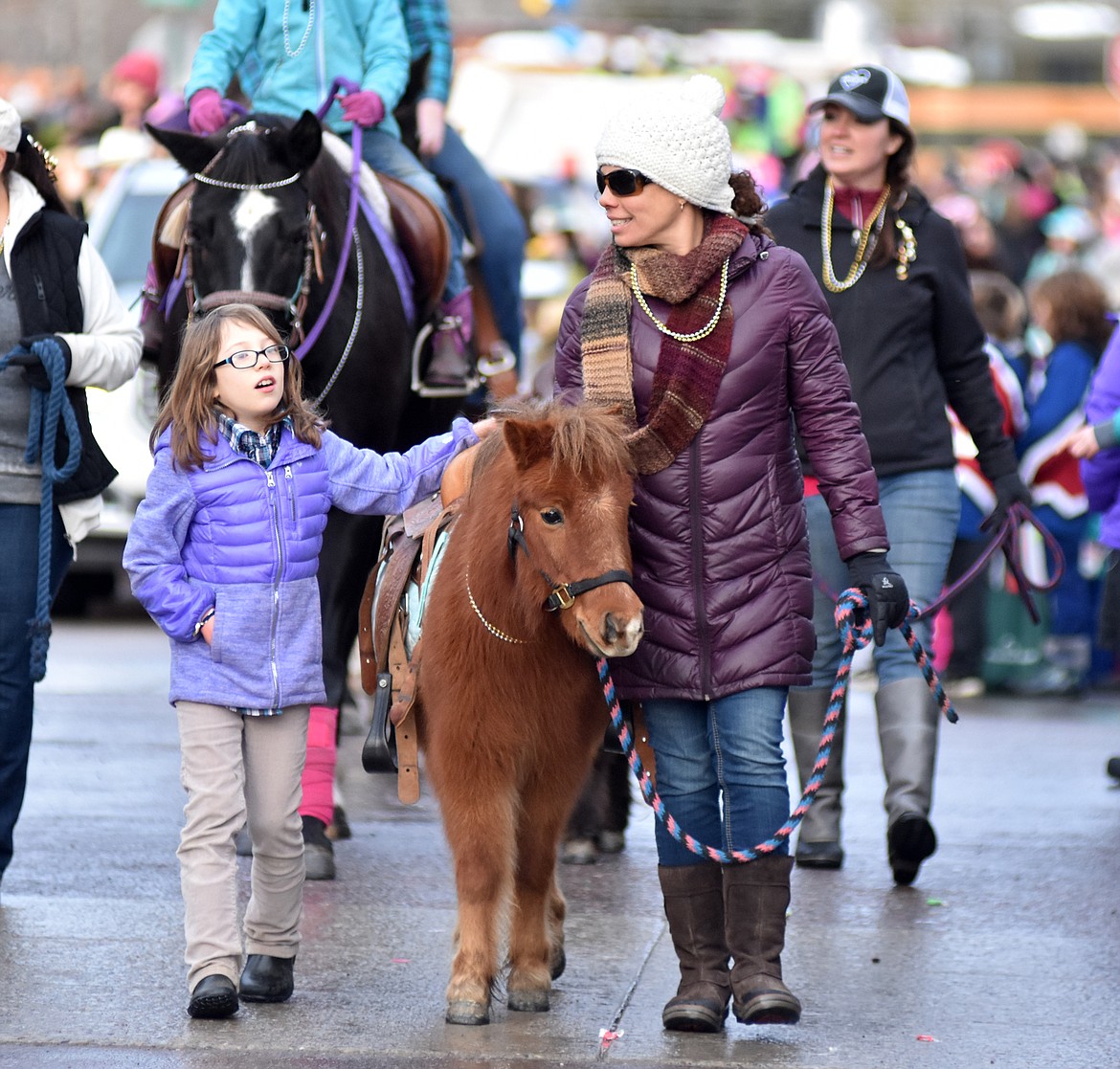 The Firefly Horse Co. walks Central Avenue during the parade. (Heidi Desch/Whitefish Pilot)