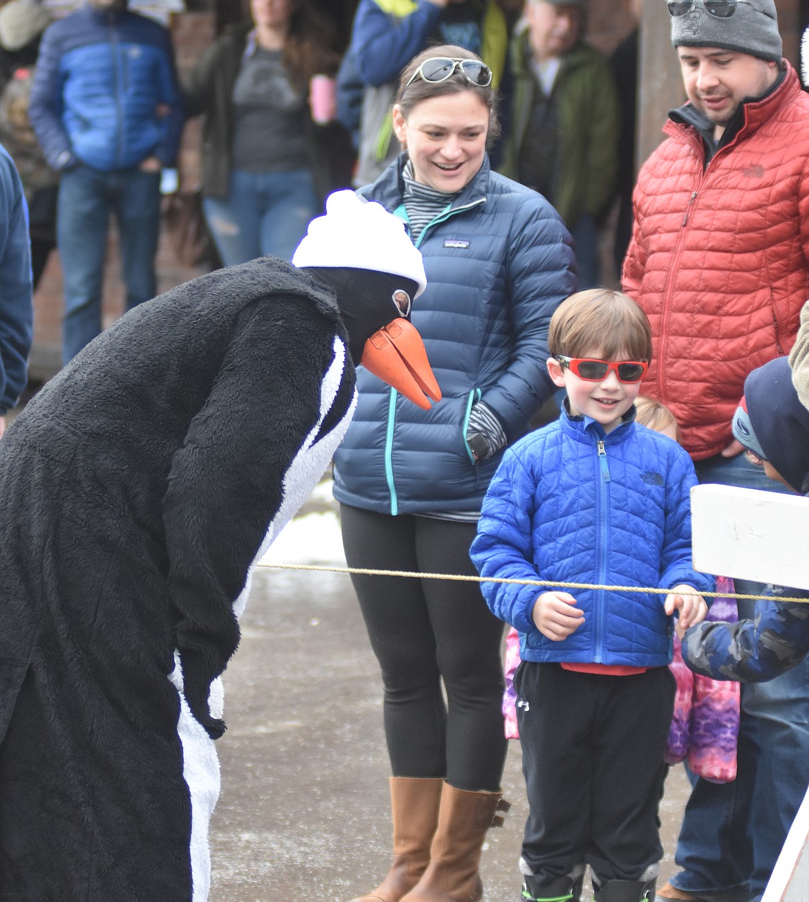 A Penguin greets parade goers before the start of the Whitefish Winter Carnival Grand Parade. (Heidi Desch/Whitefish Pilot)