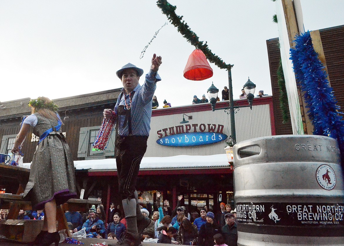 Tony Veseth tosses beads to the crowd from the Whitefish Chamber of Commerce Oktoberfest float Saturday during the Grand Parade. (Heidi Desch/Whitefish Pilot)