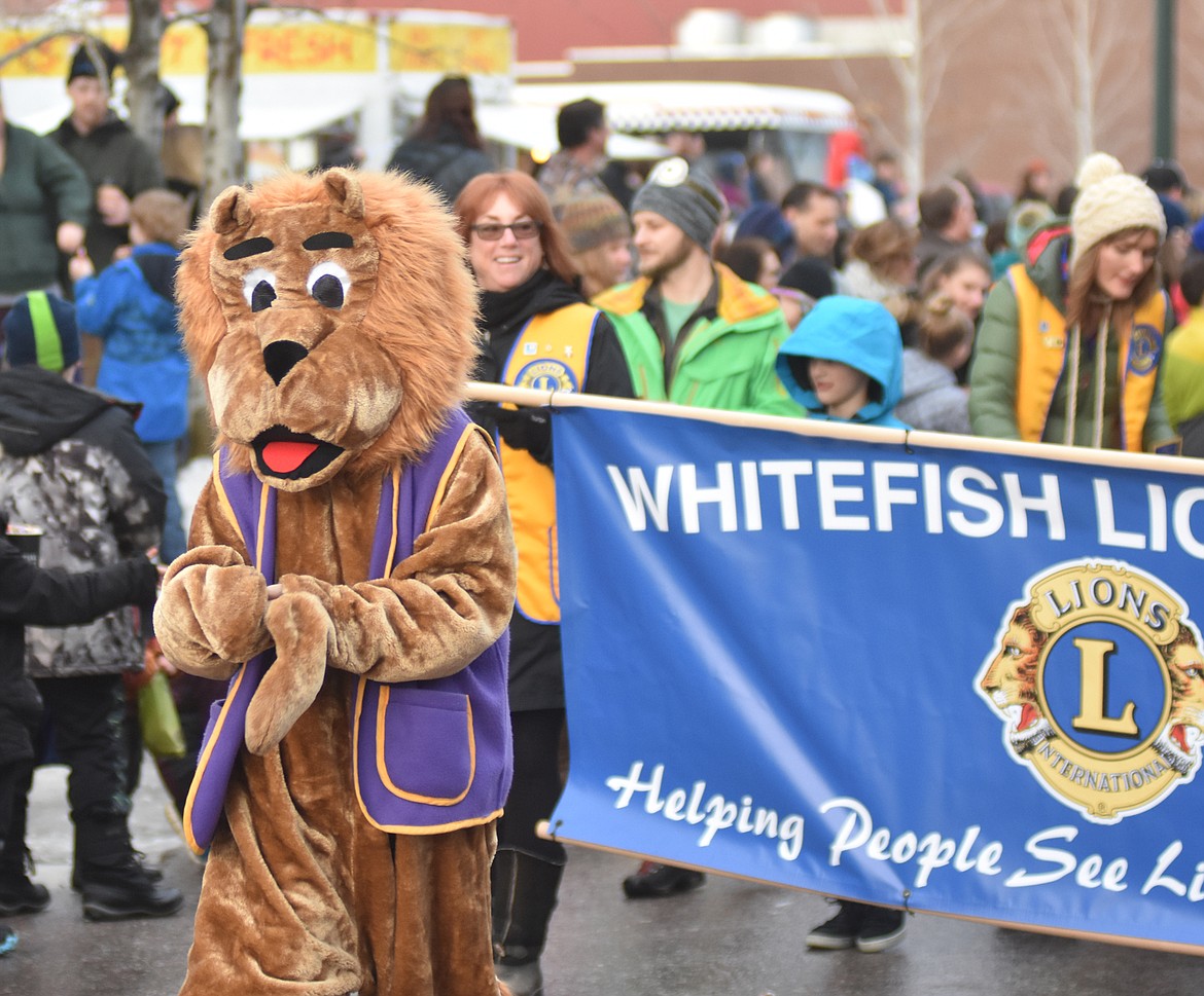 The Whitefish Lions Club walks down Central Avenue. (Heidi Desch/Whitefish Pilot)