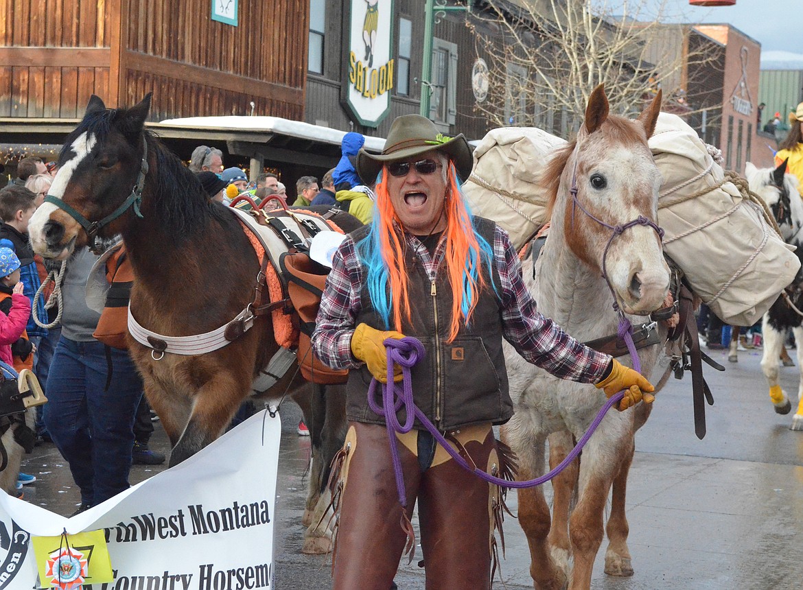 The Backcountry Horsemen walk Central Avenue. (Heidi Desch/Whitefish Pilot)