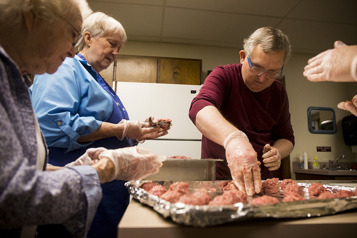 LOREN BENOIT/Press
From left, June Gilseth, Judy Edwards and Dave Jacobson prepare meatballs for the Lutefisk and Lefse dinner that will be held Saturday at Trinity Lutheran Church in Coeur d&#146;Alene.
