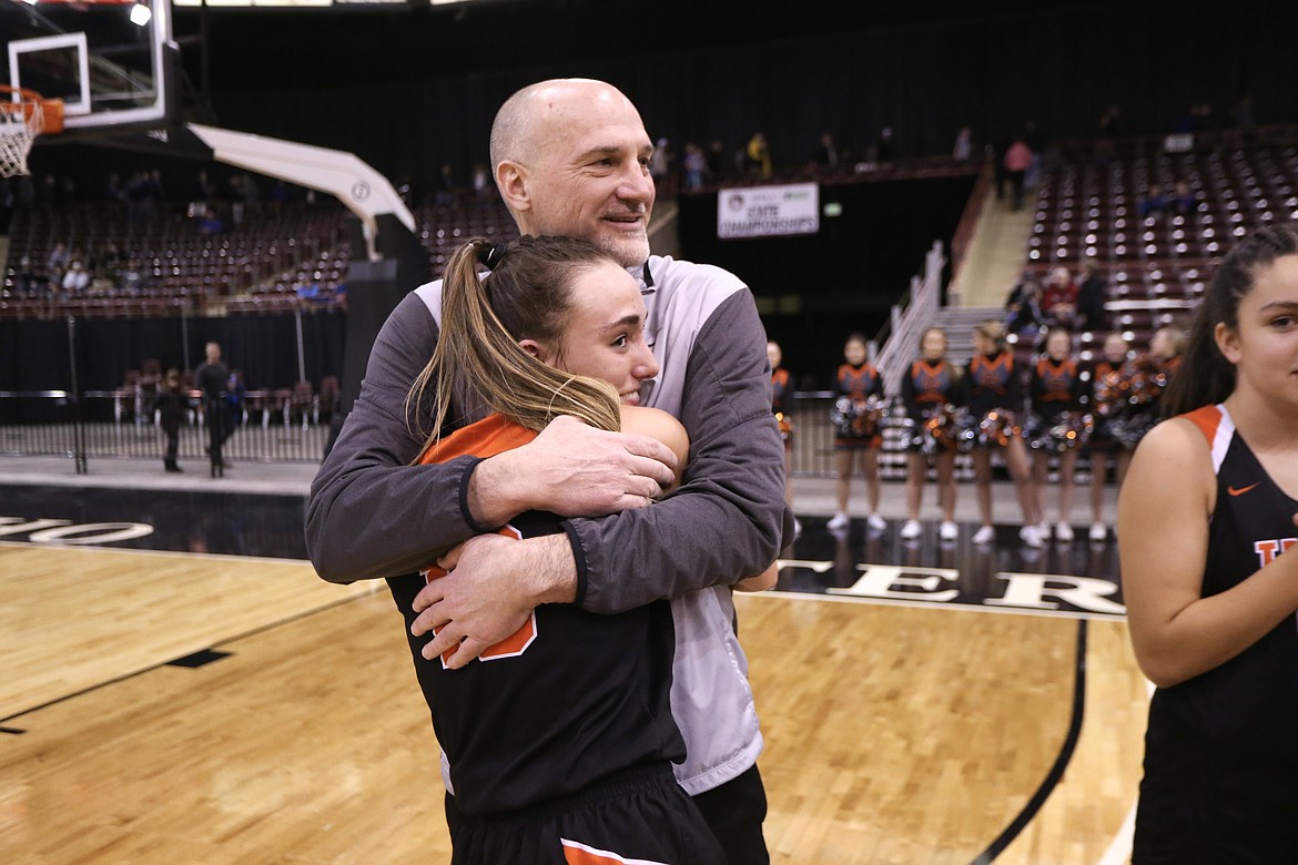 JASON DUCHOW PHOTOGRAPHY
Post Falls girls basketball coach Marc Allert hugs senior point guard Bayley Brennan after the Trojans beat Eagle to win the state 5A championship Saturday night at the Ford Idaho Center in Nampa. Allert, in his seventh season as coach, also guided the Trojans to the 2013 state title.