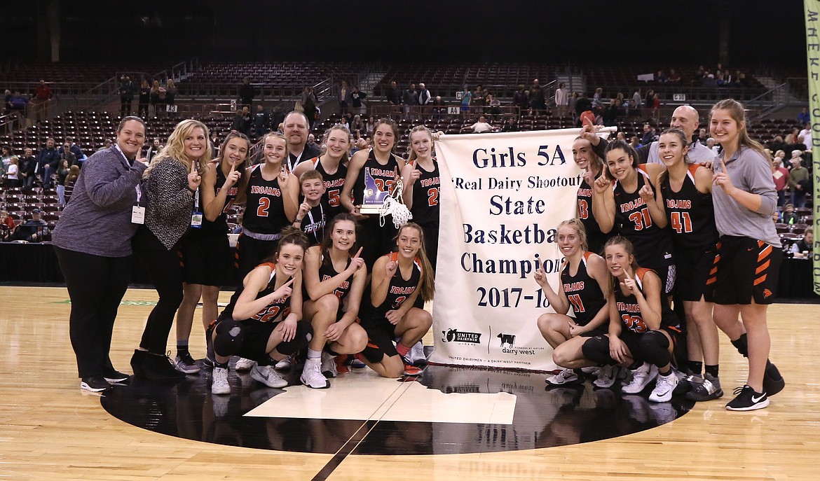 JASON DUCHOW PHOTOGRAPHY
The Post Falls Trojans pose with the championship banner after beating Eagle to win the state 5A high school girls basketball title Saturday night at the Ford Idaho Center in Nampa.