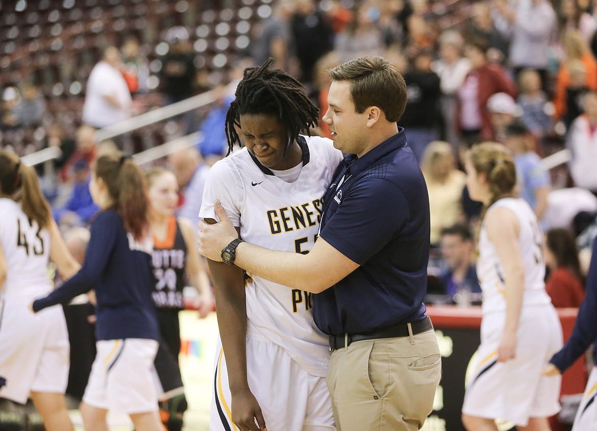 JASON DUCHOW PHOTOGRAPHY
Genesis Prep senior Bella Murekatete is consoled by coach Brandon Haas after the Jaguars lost to Butte County in the championship game of the 1A Division II high school girls basketball tournament Saturday morning at the Ford Idaho Center in Nampa.