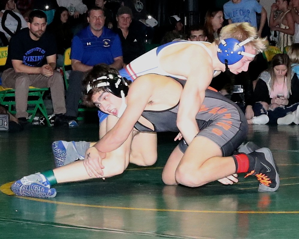 Post Falls&#146; A.J. De La Rosa, pictured shooting on Coeur d&#146;Alene&#146;s Payton Keough, scored a 7-1 decision in the 132-pound final, as the Trojans won a whopping 13 finals on Saturday.