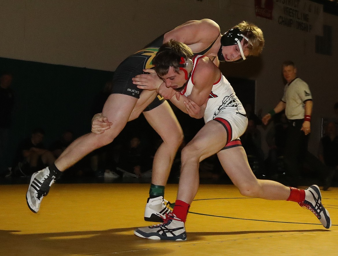 Lakeland&#146;s Luke Hellem, top, scored a 9-1 major decision over Sandpoint&#146;s Parker Coon, one of 10 district champions for the Hawks in a dominant showing.
