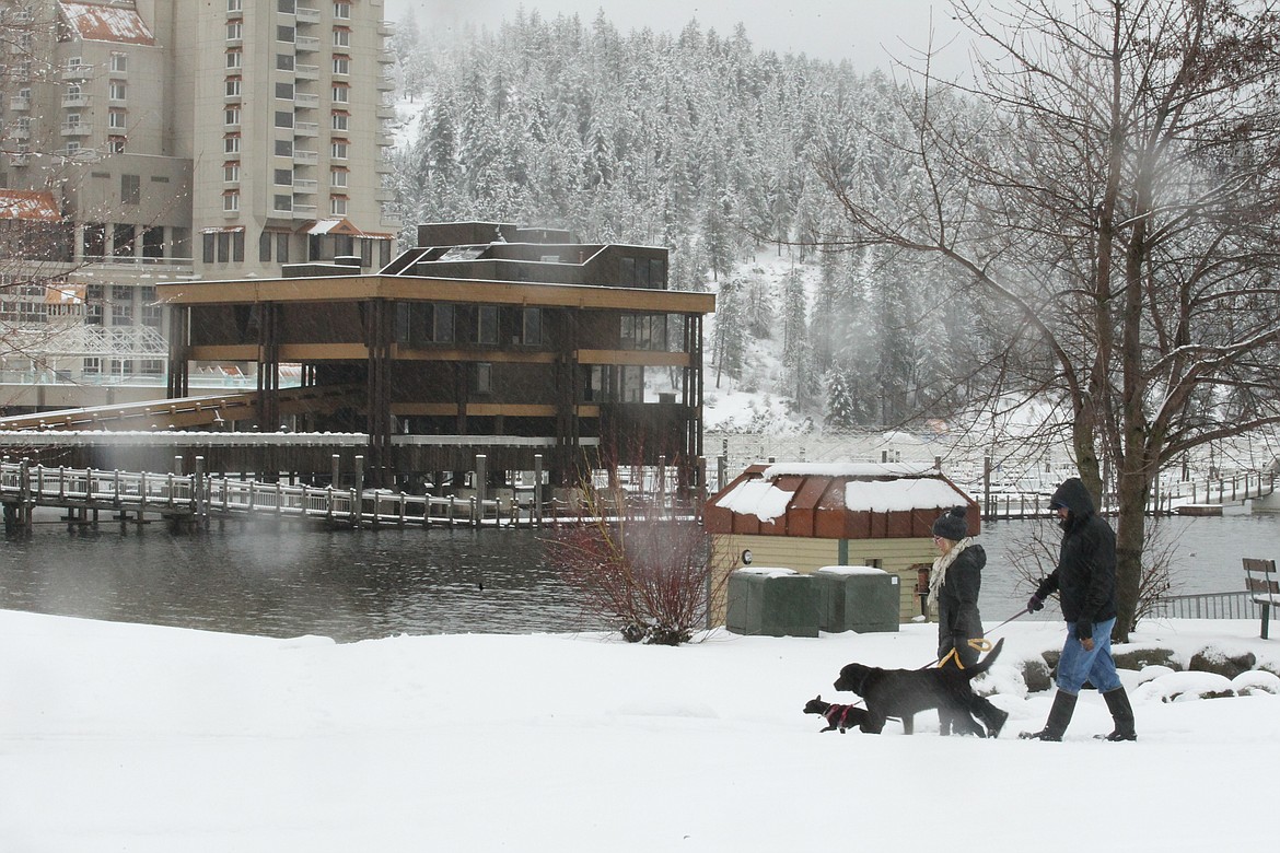 (DEVIN WEEKS/Hagadone News Network) 
Shay Young and Paul Beggerly of Coeur d&#146;Alene walk their dogs Kota and Kitty by Lake Coeur d&#146;Alene as snow turns to rain Saturday afternoon. The National Weather Service in Spokane released a winter weather message Saturday calling for  moderate to heavy snow across the Inland Northwest this weekend, with a strong and wet storm system bringing snow througout the day today.