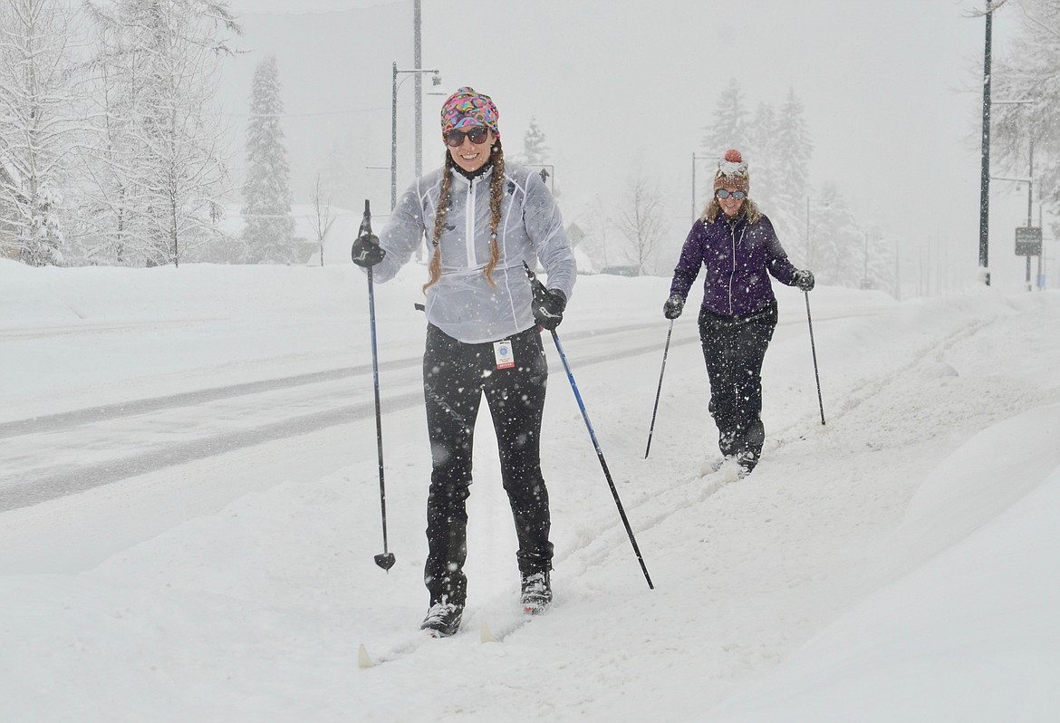 Chani Craig and Christy Daniels ski along West Second Street in Whitefish on Saturday afternoon. Bitterly cold temperatures are expected Monday, with lows near minus 20 overnight. (Matt Baldwin/Daily Inter Lake)