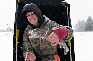 Nora Rye, of Marion, holds a rainbow trout caught during the Becoming an Outdoors-Woman ice fishing workshop at Pine Grove Pond on Saturday. (Casey Kreider/Daily Inter Lake)