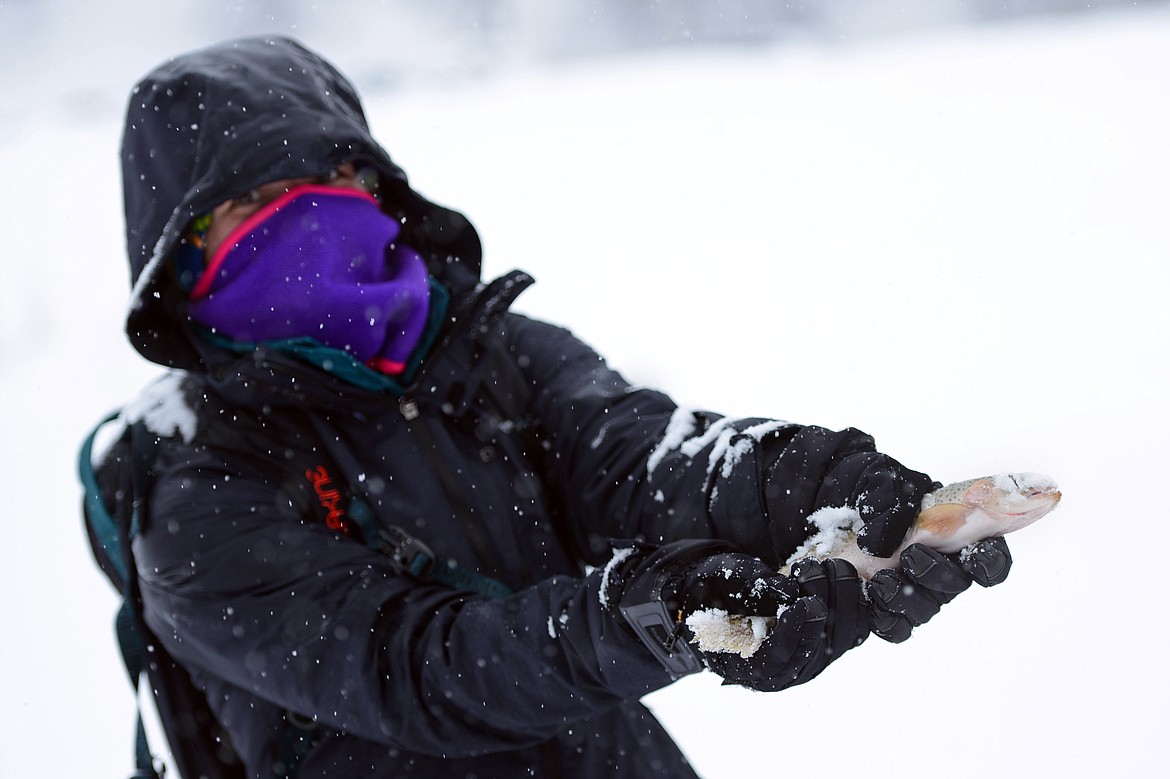 Kim Lehman, of Kalispell, holds a rainbow trout caught during the Becoming an Outdoors-Woman ice fishing workshop at Pine Grove Pond on Saturday. (Casey Kreider/Daily Inter Lake)