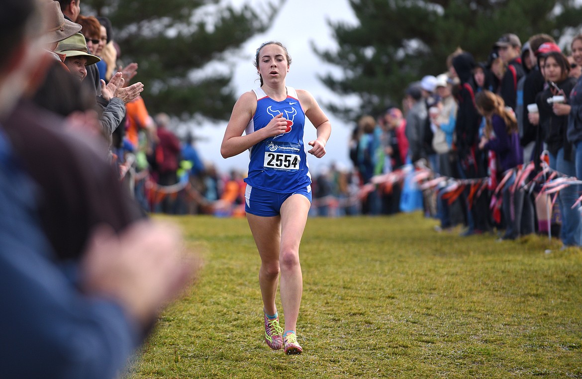 Bigfork junior Bryn Morley runs down the hill on the first lap of the Montana Cross Country Championship at Rebecca Farm on Saturday. Morley won the Class B Girls State Championship and the team finished second. (Aaric Bryan/Daily Inter Lake)