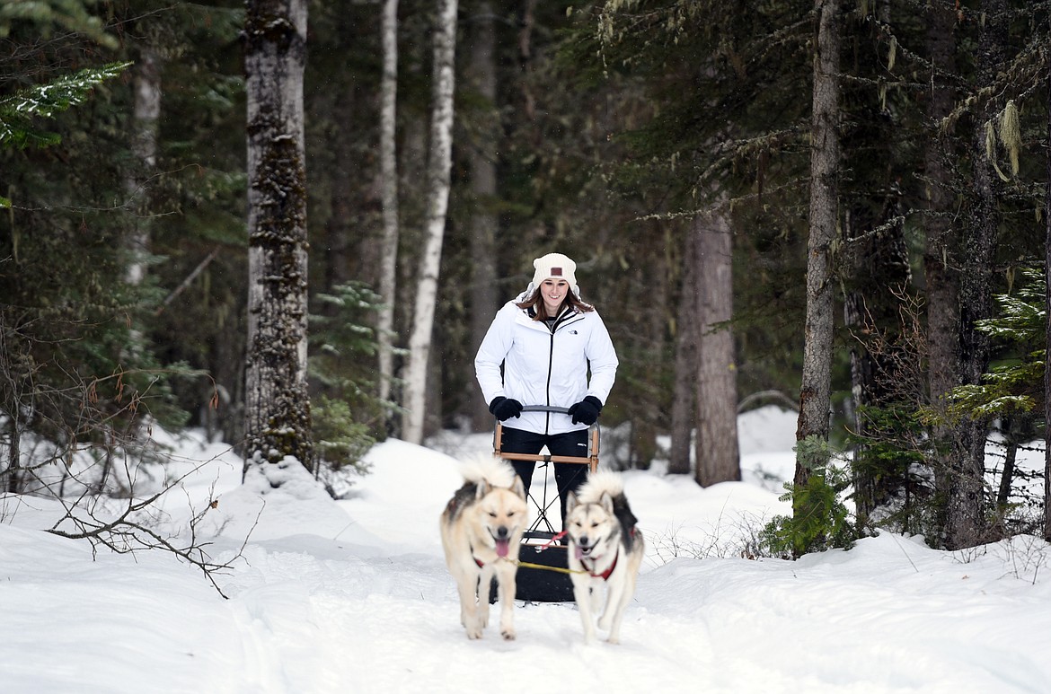 Claire Goodson, 26, of Atlanta, makes her way through a forested trail at Base Camp Bigfork.