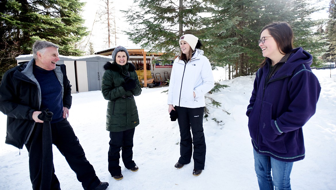 From left, Brad Goodson and his wife Amy, and daughter Claire, chat with Samantha Schurke following their trail run at Base Camp Bigfork on Friday, January 26.(Brenda Ahearn/Daily Inter Lake)