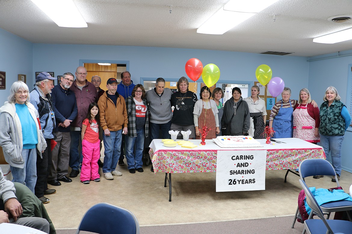 (Photo by MARY MALONE)
A group of United Methodist Church congragation members and community members gathered around a large cake Thursday in celebration of the 26th anniversary of the Community Meal program.