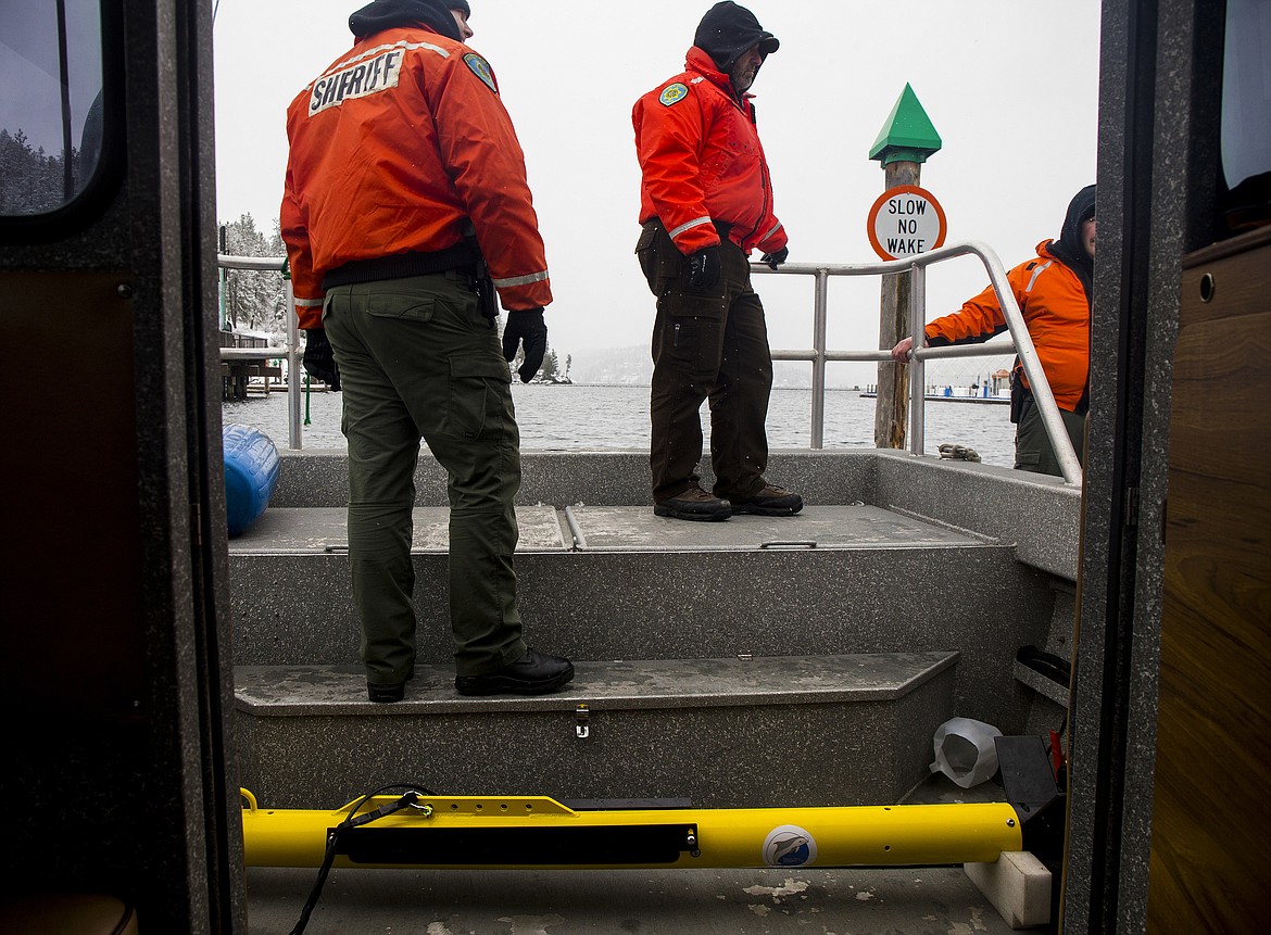 Kootenai County Sheriff personnel prepare to jet off Third Street dock with a remotely operated vehicle (in yellow) aboard a boat to scan for Larry Isenberg.