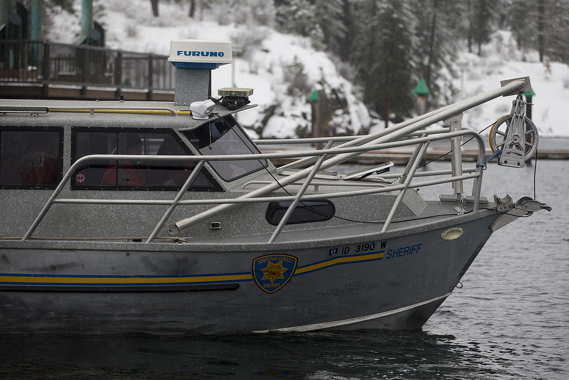 A Kootenai County Sheriffs boat jets off Third Street dock to scan for Larry Isenberg, who was reported to have fallen into Lake Coeur d'Alene near Powderhorn Bay Tuesday morning. (LOREN BENOIT/Press)