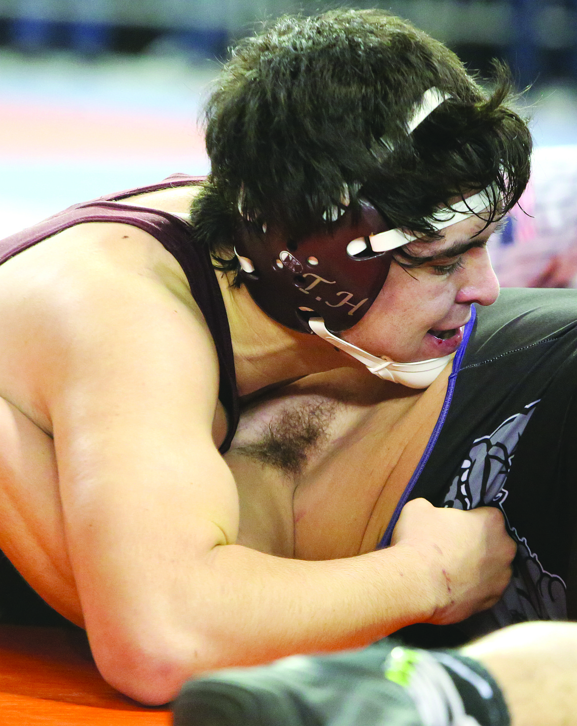 Connor Vanderweyst/Columbia Basin HeraldMoses Lake's Bailey Sanchez scores back points against Pasco's Dominick Almaguer during a consolation match at Mat Classic XXX.