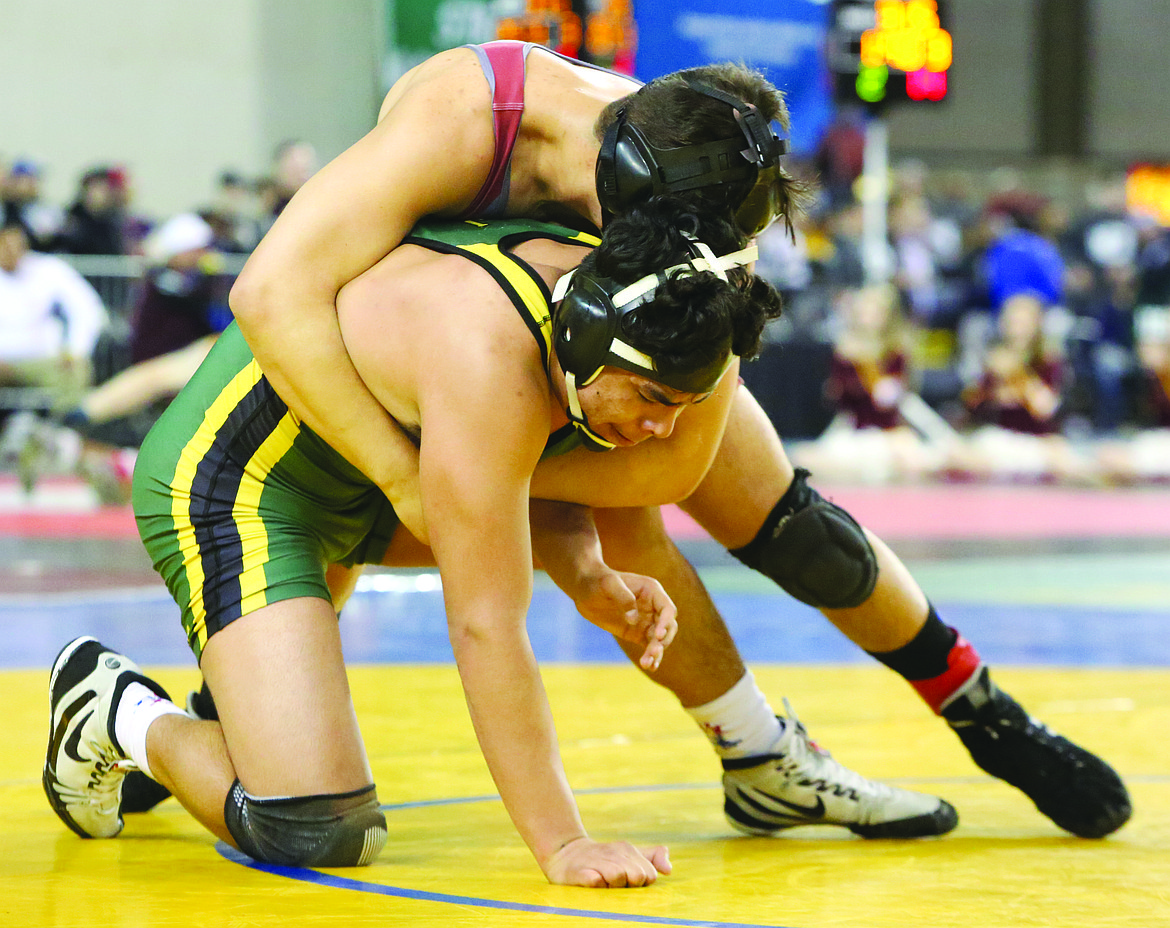 Connor Vanderweyst/Columbia Basin HeraldQuincy's Victor Tafoya (green) tries to free himself from the grasp of Toppenish's Carson Northwind during the 170-pound semifinals at Mat Classic XXX.