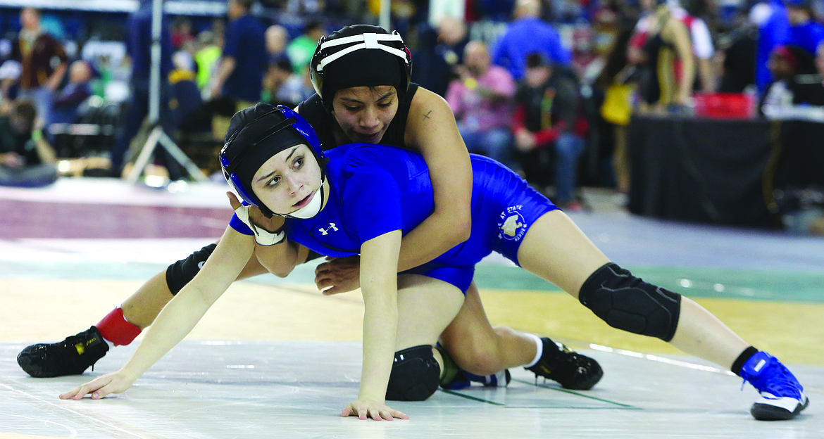 Connor Vanderweyst/Columbia Basin HeraldWarden's Aaliyah Escamilla wrestles Moses Lake's Melanie Flores in a consolation match at Matt Classic XXX.