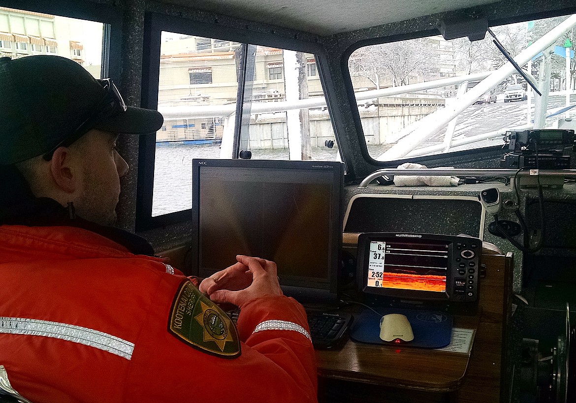 Jeff Howard, of the Kootenai County Sheriff's Office, explains sonar equipment on Wednesday on Lake Coeur d'Alene. The KCSO searched for Larry Isenberg in the area of Powderhorn Bay in the southeast portion of the lake. (BRIAN WALKER/Press)