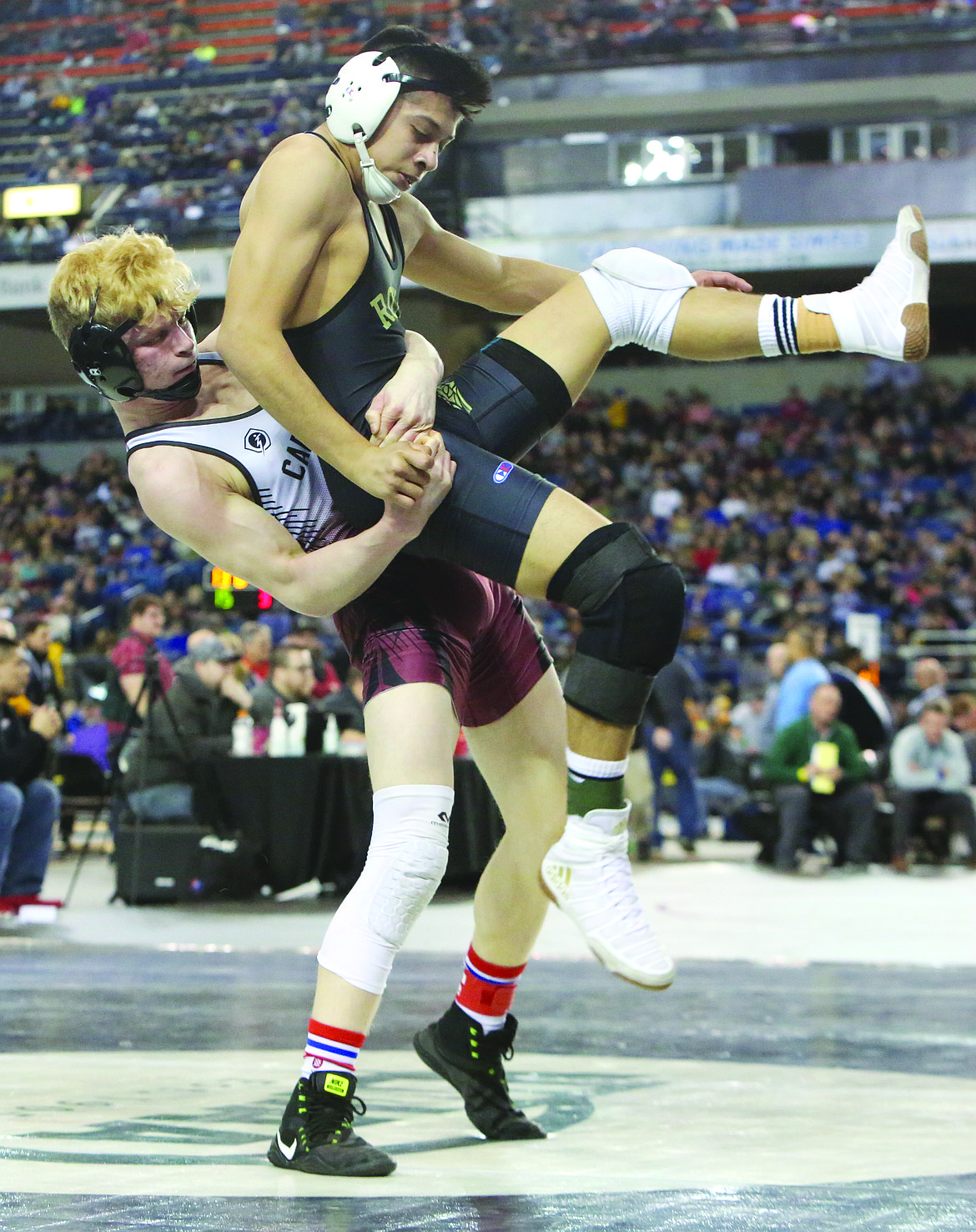 Connor Vanderweyst/Columbia Basin HeraldRoyal's Eduardo Rodriguez (black) is lifted into the air by Medical Lake's Ethan Davis during the 132-pound semifinals at Mat Classic XXX