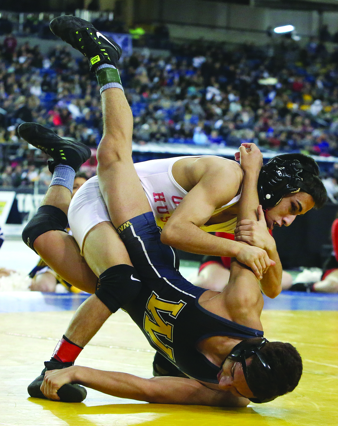 Connor Vanderweyst/Columbia Basin HeraldOthello's Chris Melo (white) tries to keep Wapato's Uriel Garcia down during the 106-pound championship.