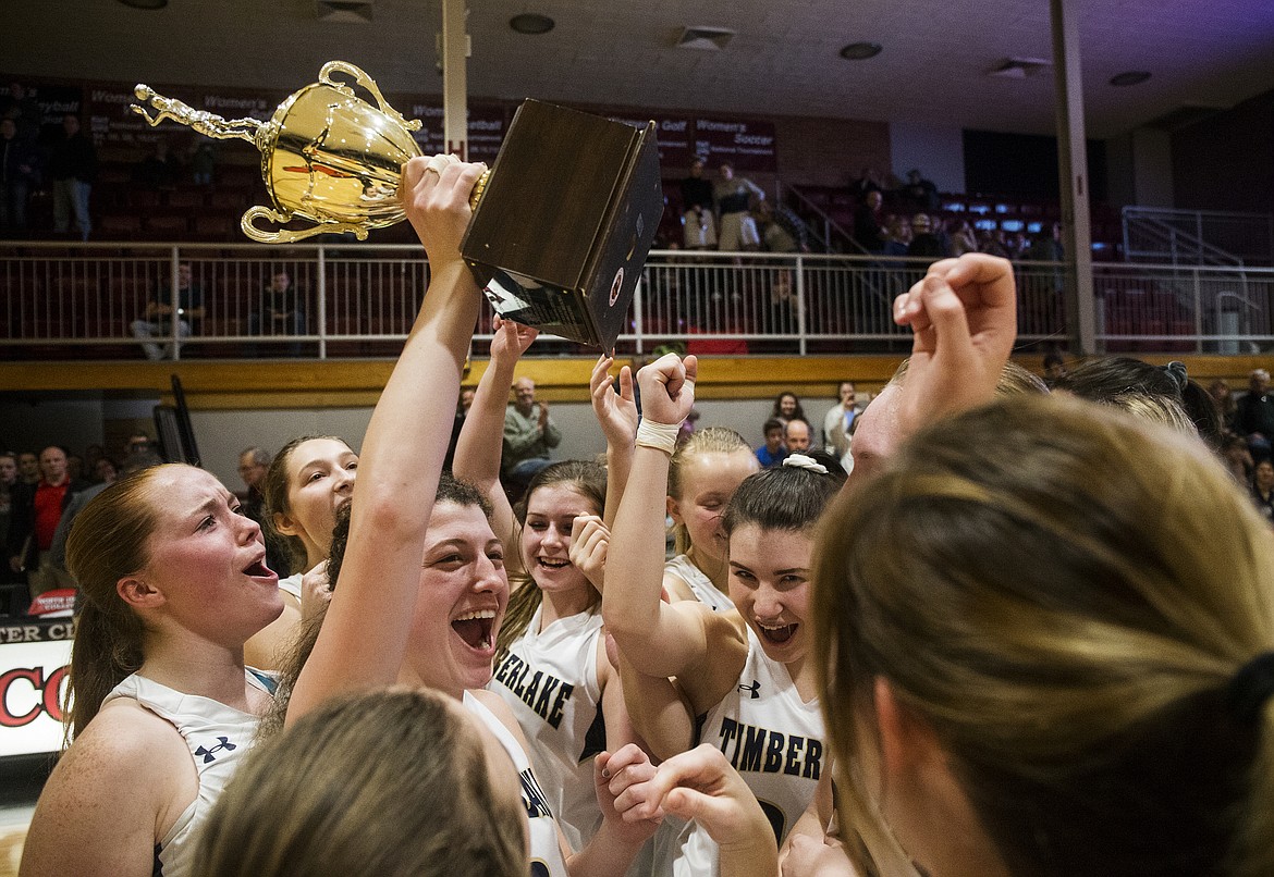 Timberlake players celebrate their 3A District 1 girls basketball championship win over Kellogg on Wednesday night at North Idaho College.