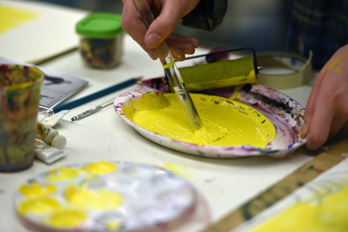 Anna Hedinger, a junior at Flathead High School, mixes paint as she works on a new wave movie poster for the 1961 French film &#147;Une femme est une femme&#148; or &#147;A woman is a woman&#148; in teacher Kristie Caratelli&#146;s International Baccalaureate art class on Friday. (Casey Kreider/Daily Inter Lake)