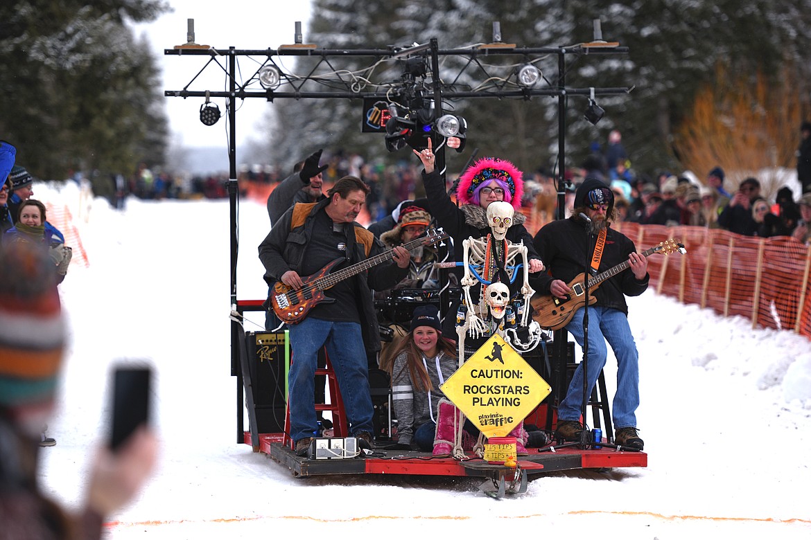 A band plays on a sled heading down Sugar Hill during Cabin Fever Days in Martin City on Saturday. (Casey Kreider/Daily Inter Lake)