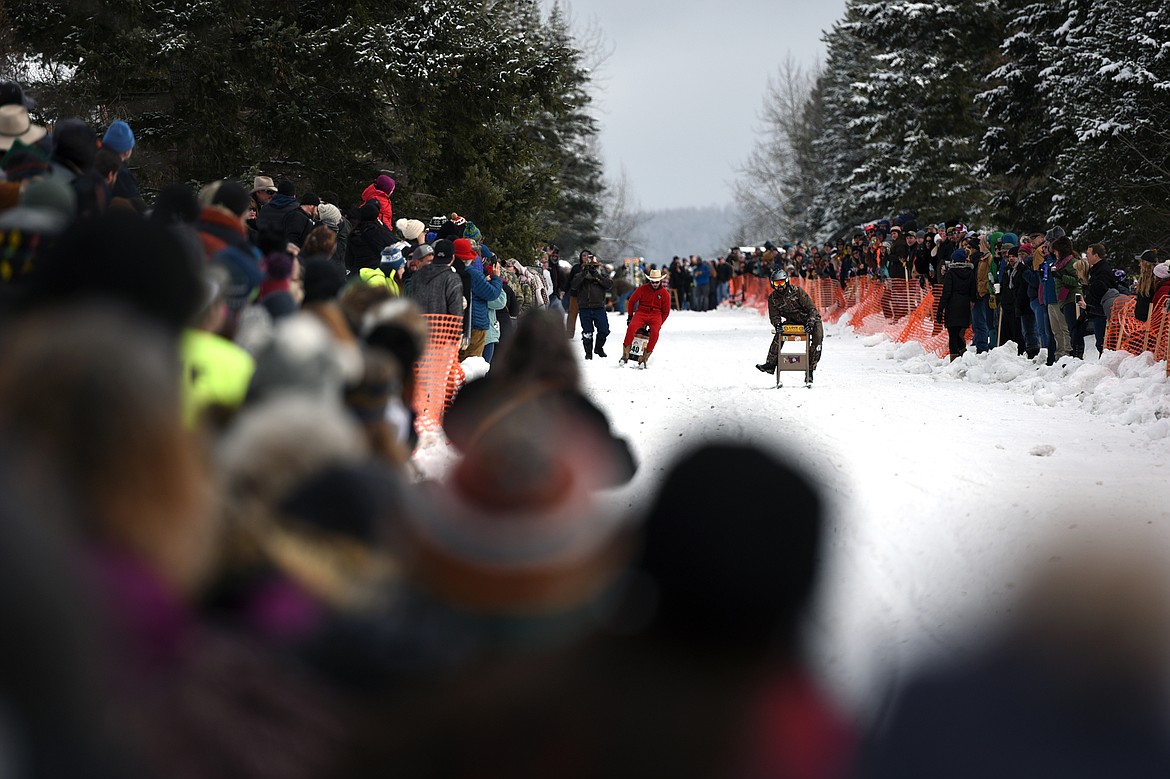 Barstool skiers race down Sugar Hill during Cabin Fever Days in Martin City on Saturday. (Casey Kreider/Daily Inter Lake)