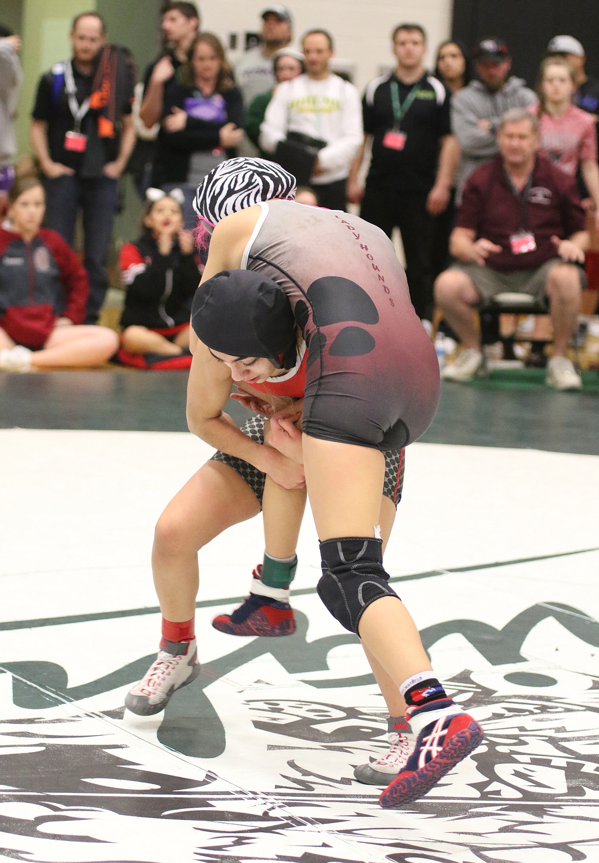 Bob Kirkpatrick/The Sun Tribune - Emily Mendez takes down Maria Reyes from Grandview. Mendez put up a good fight, but dropped the 105-pound championship match to finish runner-up.