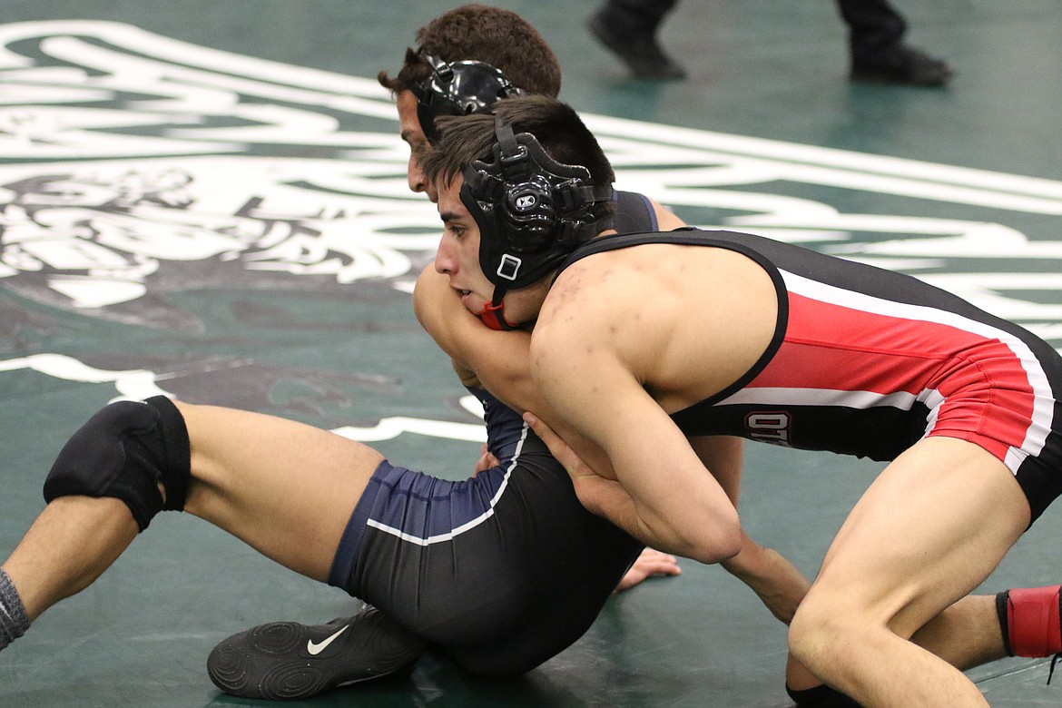 Bob Kirkpatrick/The Sun Tribune - Chris Melo pins back the left arm of Wapato&#146;s Uriel Garcia in the 106-pound championship bout. Melo took an 8-5 decision and continued his dominance on the mats.