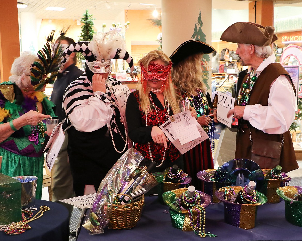 Costumed Krewe d'Alene attendees wander through The Resort Plaza Shops during the 2017 Mardi Gras celebration. This year's event will feature live entertainment and art, a professional drag queen performance and lots of New Orleans-style food from seven local restaurants. (Courtesy photo)