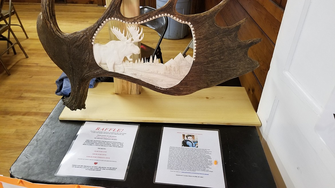 Photo by Mandi Bateman
Hand carved moose paddle by master carver Bob Graham was us for raffle to benefit Abigail Blockhan. It will be on display next at Far-North Outfitters and tickets will be available there.