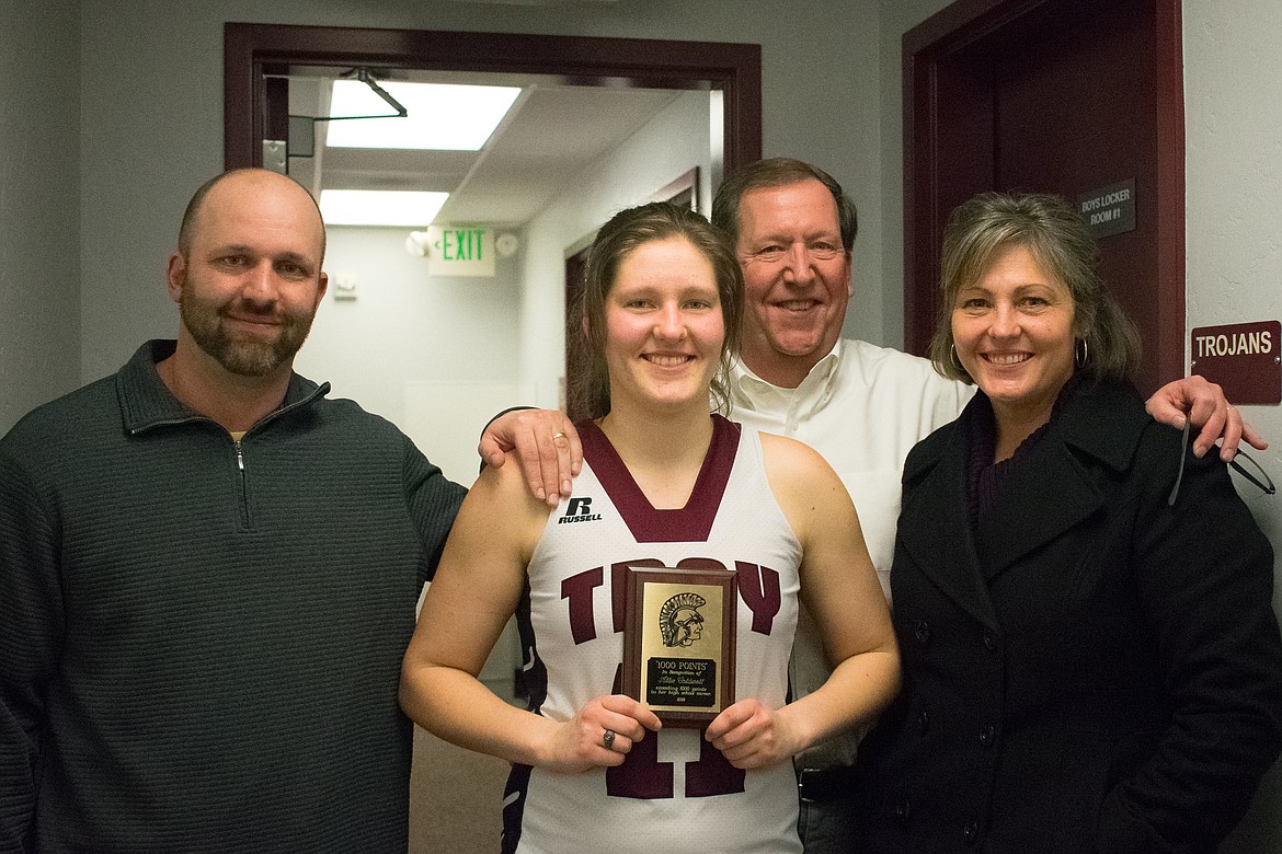 Troy High School senior hoopster Allie Coldwell got a plaque Feb. 9 for scoring 1,000 points in her high school career. Pictured are Coach Justin Young, Allie and her parents Darren and Barbie Coldwell. (Ben Kibbey/The Western News)