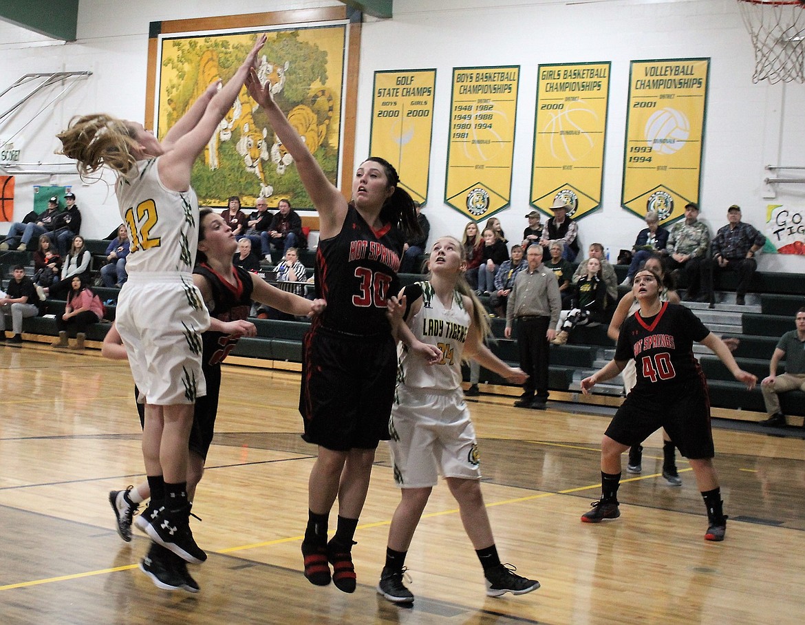 Emma Hill wards off a block from Hot Springs McKennzie Cannon during Senior Night on Feb. 8. The Lady Tigers won 41-35. (Kathleen Woodford photos/Mineral Independent)