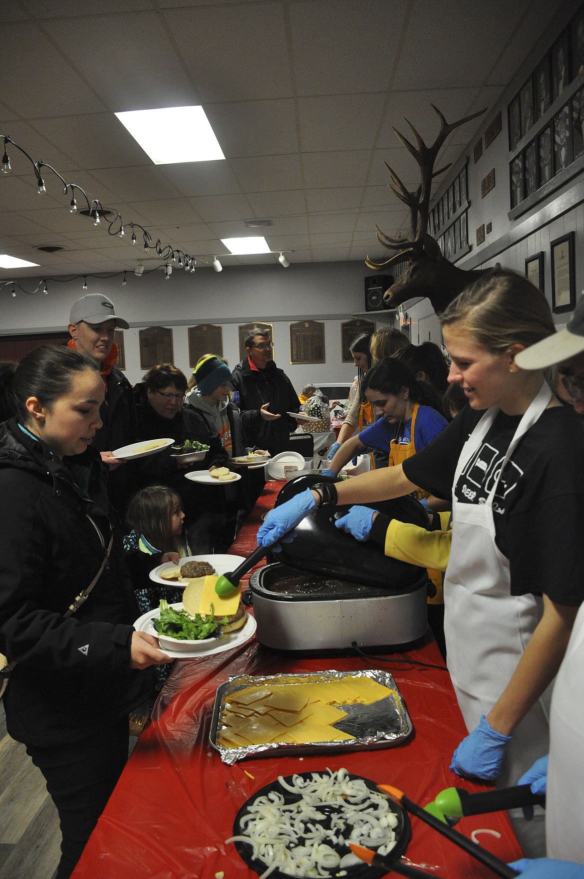 PEOPLE ATTEND the Buffalo Feed fundraiser held by the Kiwanis Club of Polson Monday evening, benefitting children&#146;s organizations around the area. (Ashley Fox/Lake County Leader)