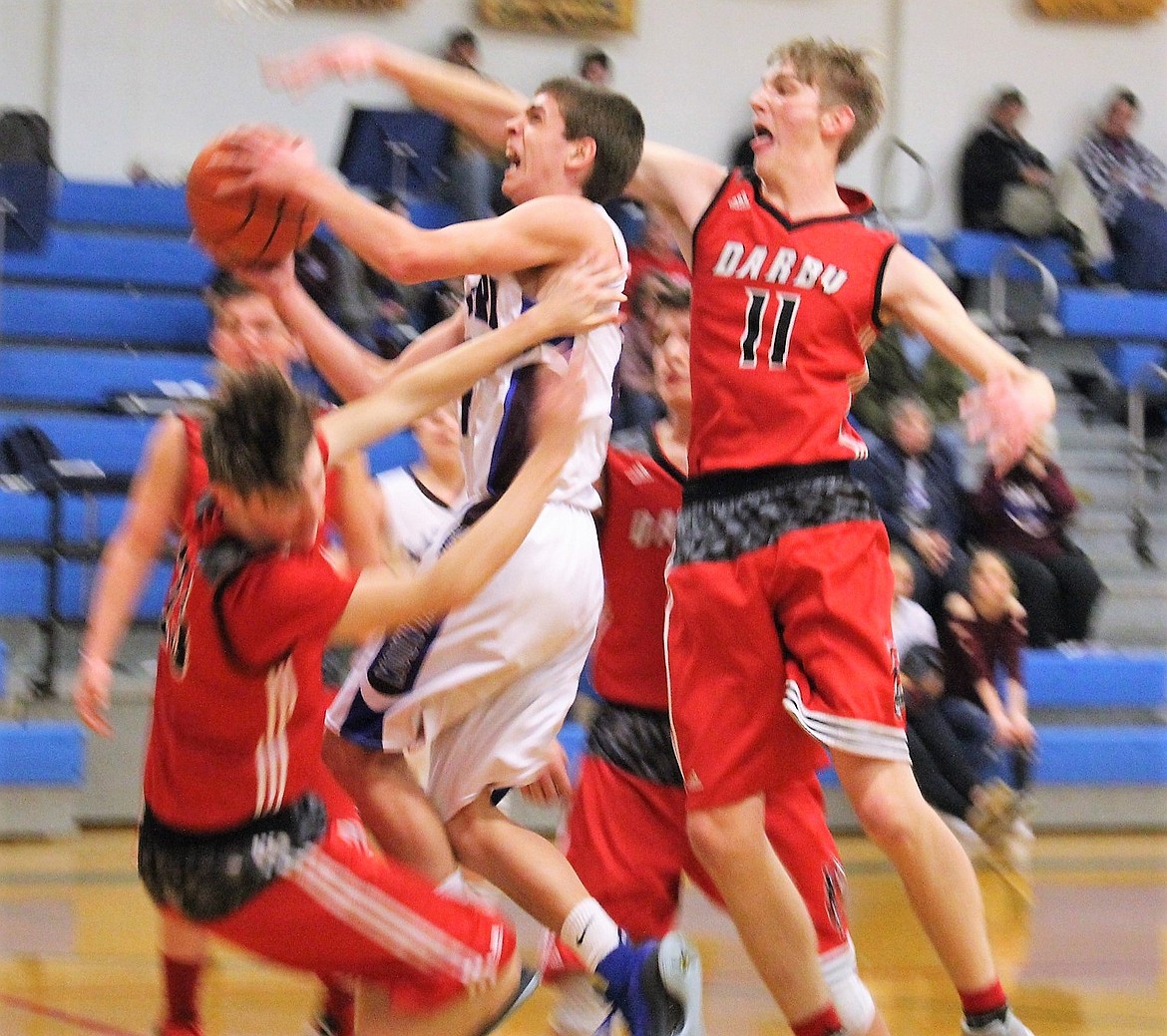 Mountain Cat Carson Callison fights for the basket against Darby during the team&#146;s game on Feb. 9 in Superior. The boys lost to the Tigers, 63-54. 
(Kathleen Woodford/Mineral Independent).