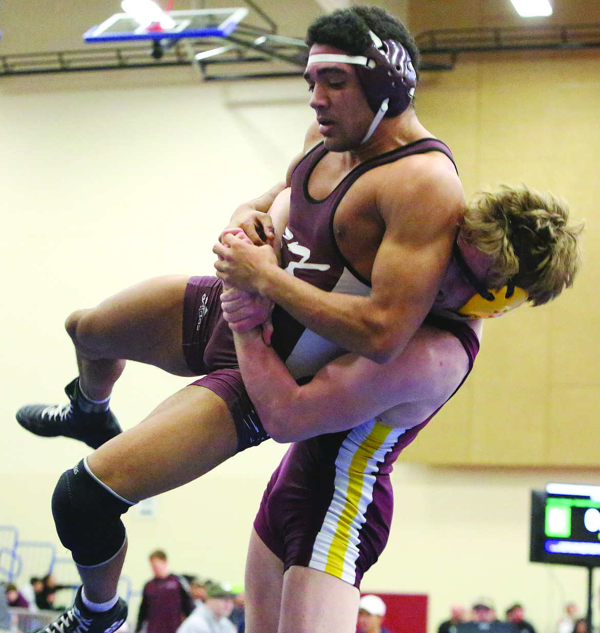 Connor Vanderweyst/Columbia Basin Herald
Moses Lake's Hunter Cruz (right) lifts South Kitsap's Davonn Keyes into the air during the regional semifinals.